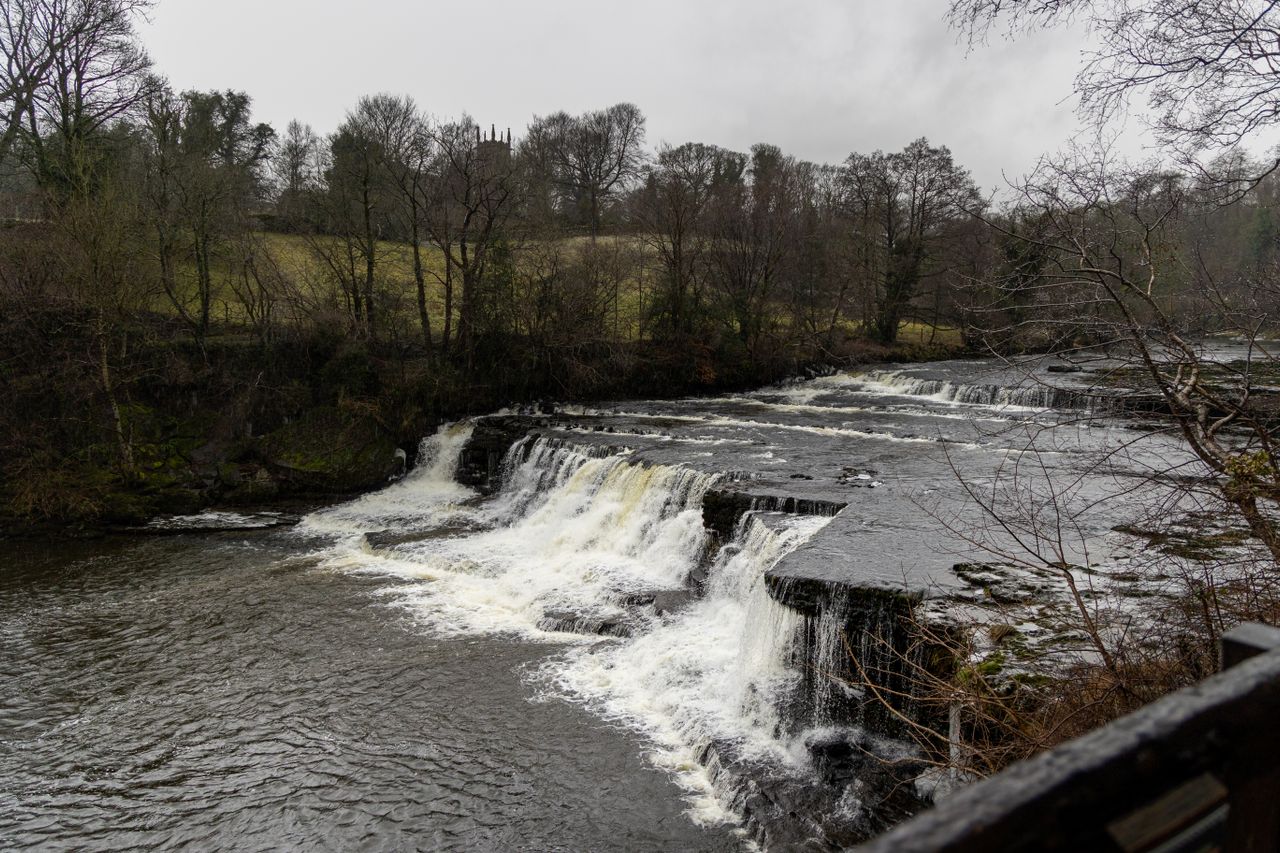 Explore the Yorkshire Dales this Summer Weetwood Hall Blog Image aysgarth falls waterfall with trees along one side